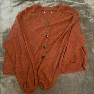 Orange sweater with brown buttons, fits like a medium